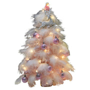 Small pink feather Christmas tree decorated with LED lights and purple ornaments, festive desktop decoration for holiday décor