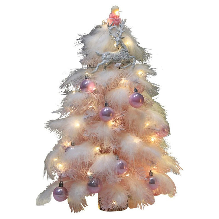 Small pink feather Christmas tree decorated with LED lights and purple ornaments, festive desktop decoration for holiday décor