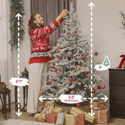 6ft flocked Christmas tree decorated with red and gold ornaments beside a 5'7" woman in a festive sweater and surrounded by wrapped gifts